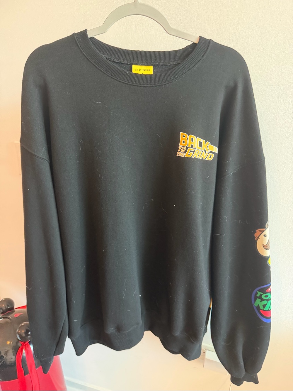 attention Black Crewneck Sweater with Yellow Chest Graphic